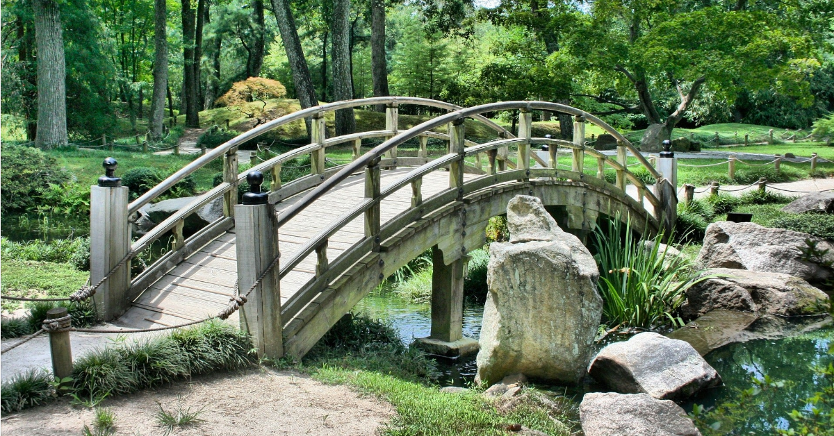 a small arched bridge over a creek